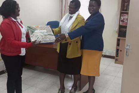 The DNS Chairman Dr Miriam Wagoro and Dr Angeline Chepchirchir, The Thematic Head  of Community Health Unit, receive the Indawo Board Game.